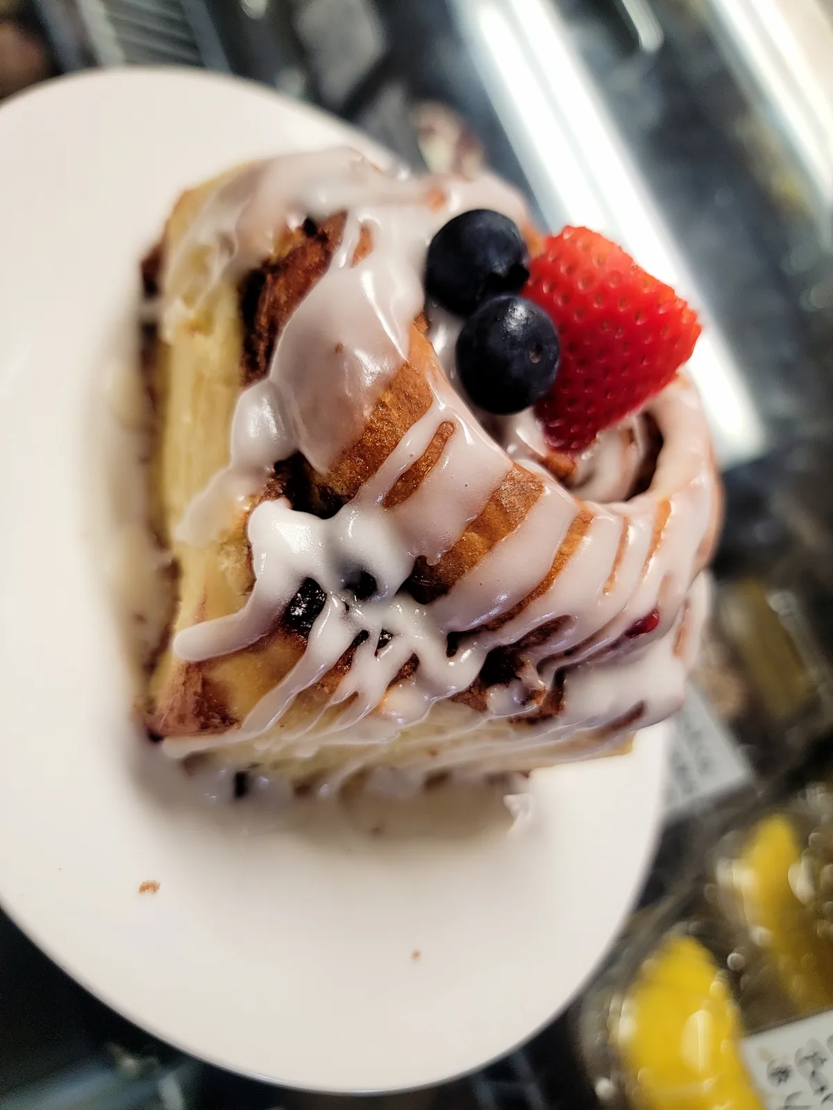 Photo placeholder: split cinnamon roll layered with macerated strawberries and whipped cream